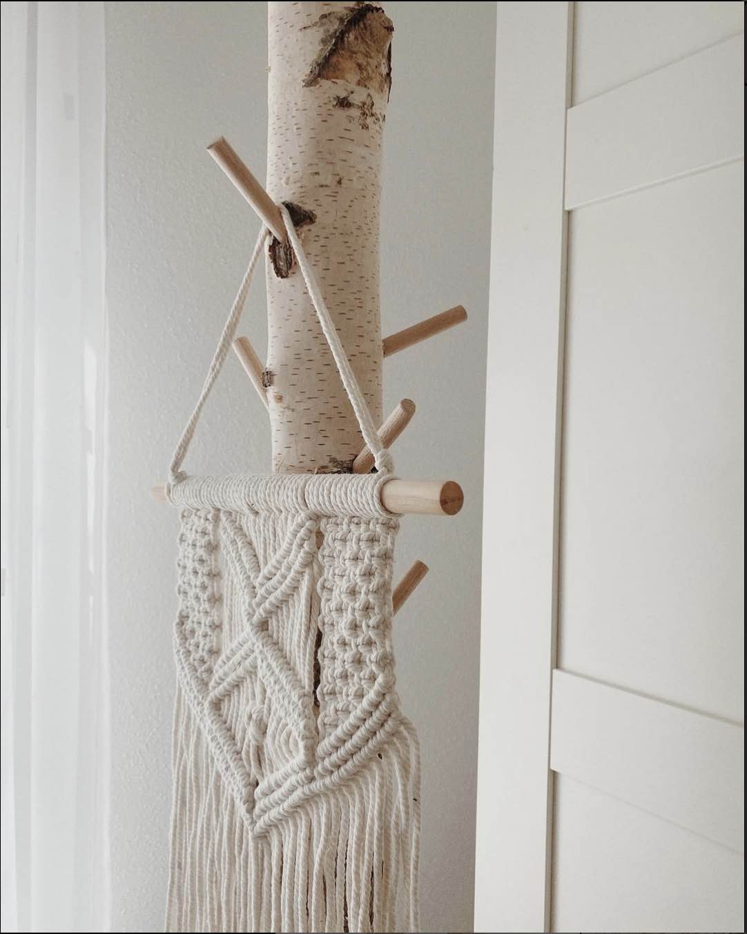 Garderobe aus einem Birkenstein mit Holzstangen um Klamotten oder Taschen aufzuhängen. 